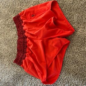 Size 4 orange lululemon running shorts